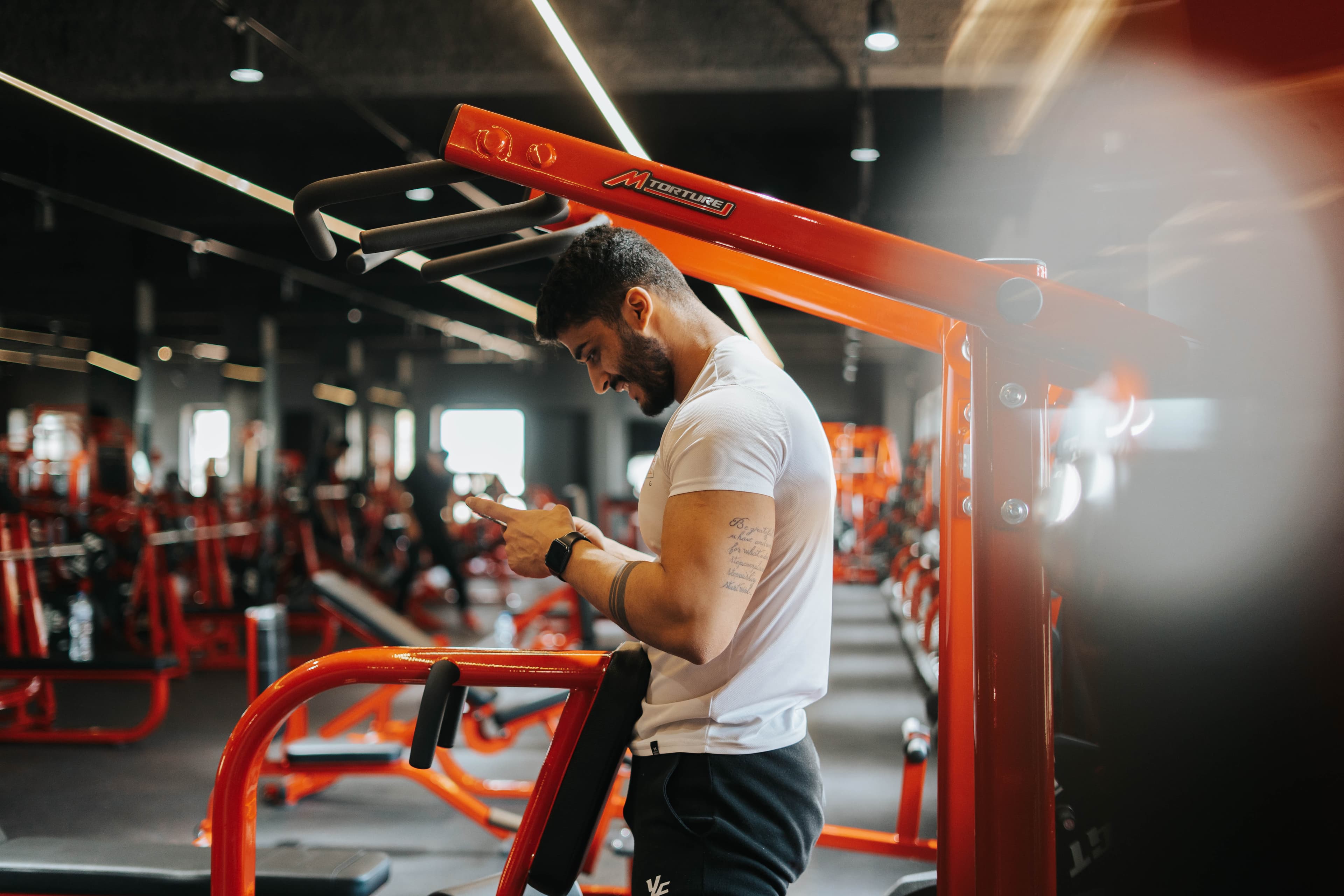 Omar working a chest press machine